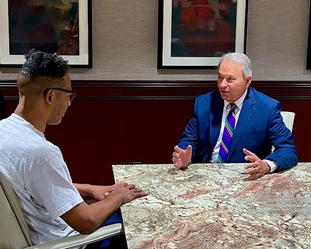 Sam Adamo, Sr. with client at conference table
